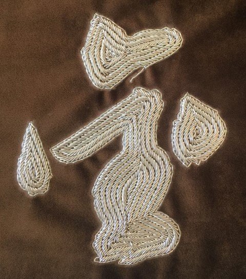 Hand embroidered metal character medallion