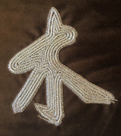 Hand embroidered wood character medallion
