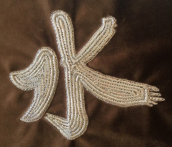 Hand embroidered water character medallion